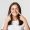 Close-up of attractive smiling young girl pointing fingers at face, poking cheeks, white background.