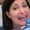 Dentist examining female patient with teeth shades at dental clinic